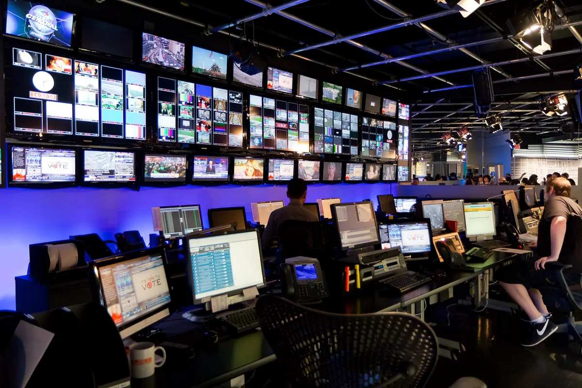 A broadcast control room with monitors, representing the systems behind an IPTV service that can suffer outages
