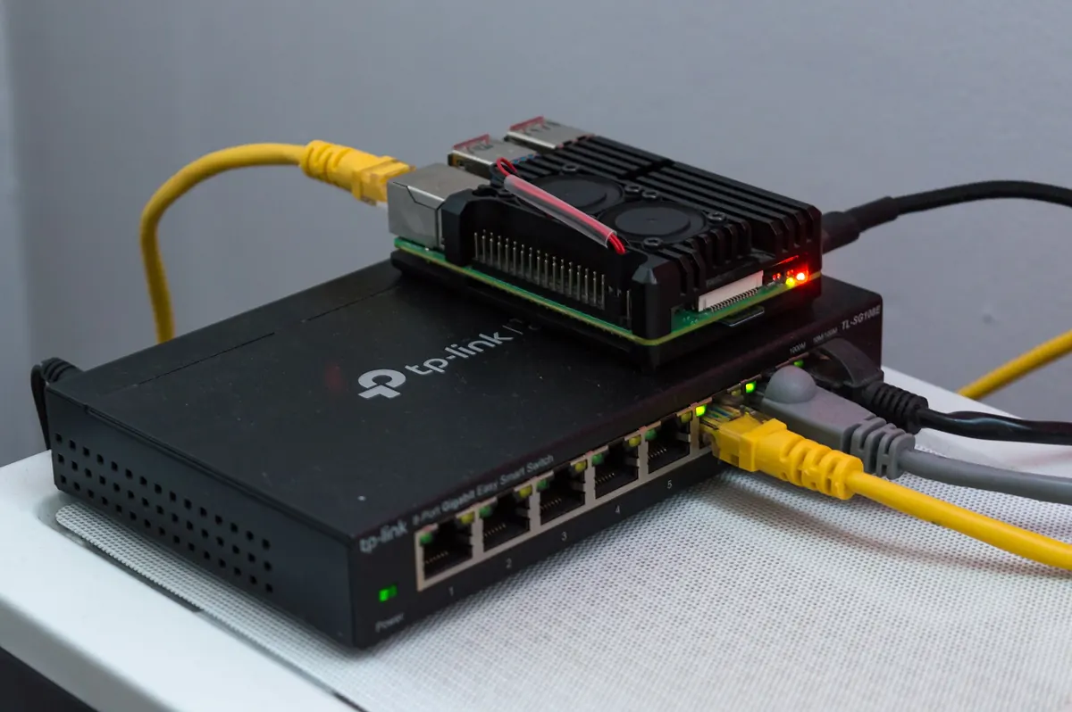 A network switch with Ethernet cables, where a hardware encoder's streams enter the local network