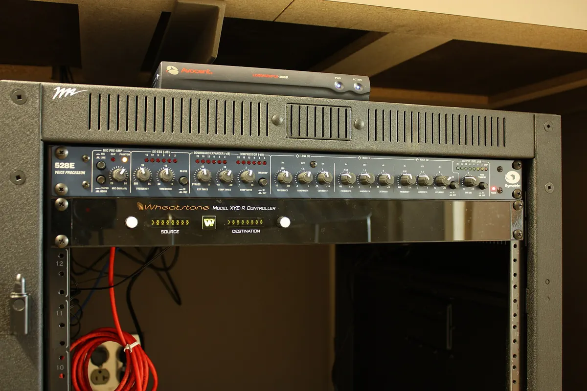 A production studio equipment rack with rack-mounted units and cabling, where 4K encoders are often installed